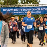 Person running towards finish line at Anti-Cancer Challenge